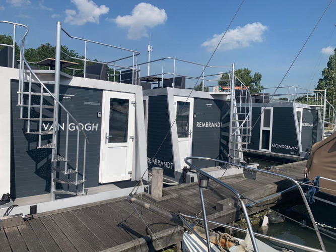 Houseboats at Harbour Lodge Amsterdam in Marina Parcs Amsterdam, each named after Dutch artists.