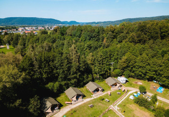 Vista aerea di Villatent Outback al Camping Au Clos de La Chaume in Francia, circondato da foresta e natura.
