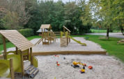 Parco giochi con sabbiera e attrezzature in legno al Camping de Beukenhof, Drenthe, Paesi Bassi.