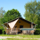 Safari tent Villatent Outback with hammock at Camping de Schatberg in the Netherlands, amidst green trees.